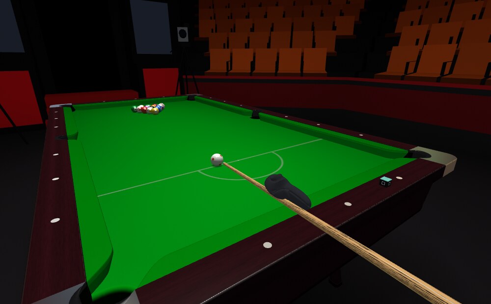 The cue down on the cue ball, aimed at the rack